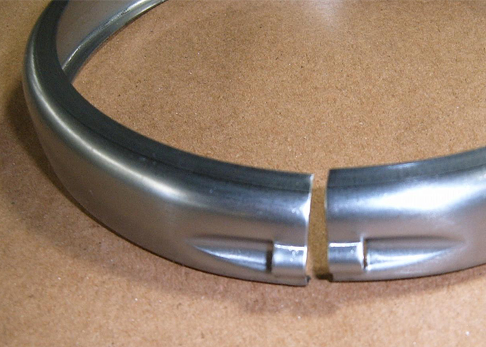 Lighting bezel with a bolt hole for tightening - MP Metals