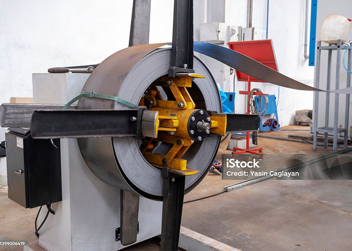 Uncoiler machine at the start of a rollforming machine - MP Metals